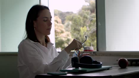 slow motion, woman sitting at home office desk starting working day