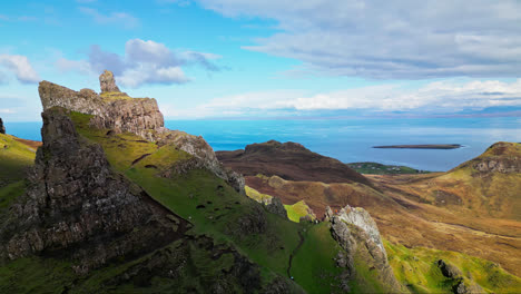 Cloud-casts-shadows-over-vibrant-grassy-green-cliffs-of-the-Scottish-Highlands