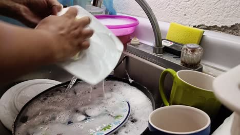 a view of washing the dish after eating at the sink