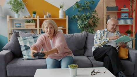 older couple relaxing at home, playing video games