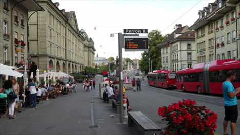 busy city street scene with tram and people
