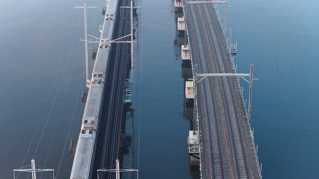 Train Crossing Old Raritan River Drawbridge with New Bridge Under Construction in Perth Amboy New Jersey USA Aerial View