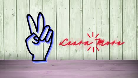 Neon-learn-more-text-and-hand-peace-symbol-against-wooden-background