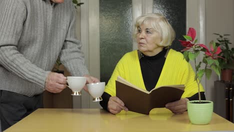 happy elderly couple sitting at table together