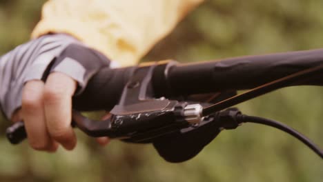 Close-up-of-mountain-biker-pressing-brake