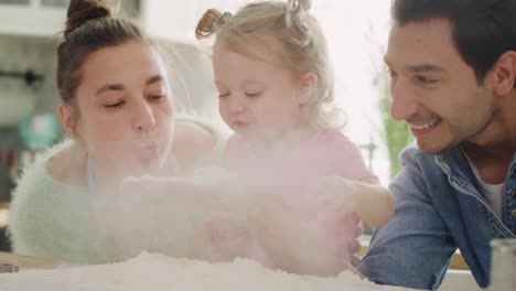 Handheld-view-of-whole-family-playing-with-flour-in-kitchen