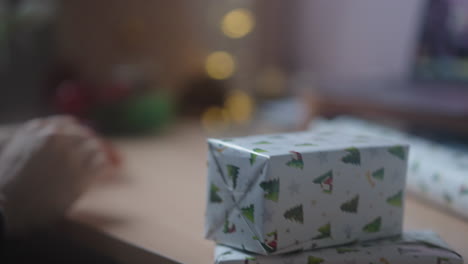 close up of party host, wrapping and arranging gift boxes with decorative paper