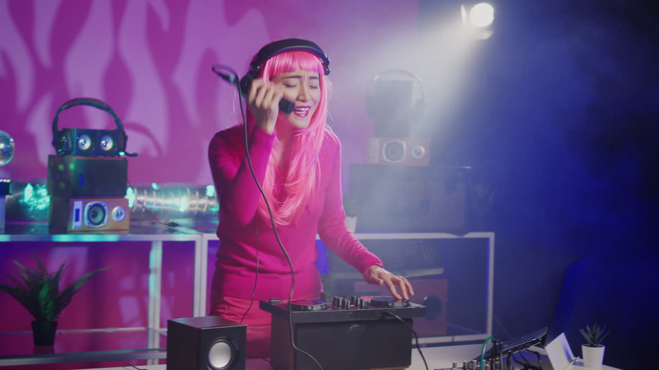 DJ with pink wig playing music