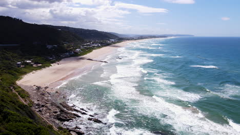 Drone-tilt-up-reveal-of-breathtaking-stretch-of-white-sand-beach,-Wilderness