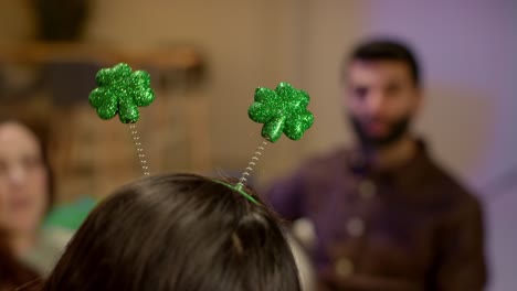 close up of friends dressing up with irish novelties and props at home celebrating at st patrick's day party