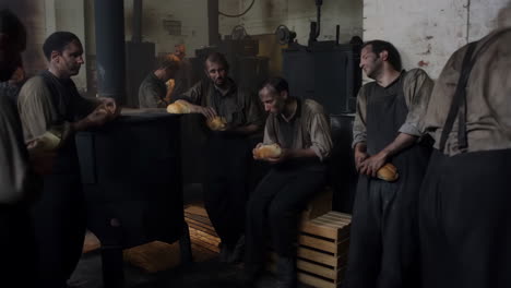group of men in factory with bread