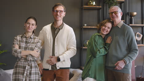 happy family posing and looking at camera while standing in a modern living room at home 1