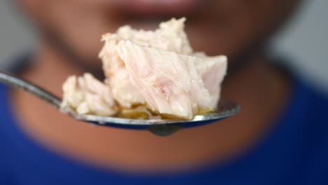 man eating tuna with a spoon