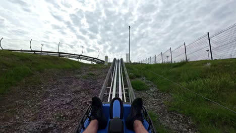 a summer toboggan run through nature in slow motion shot.