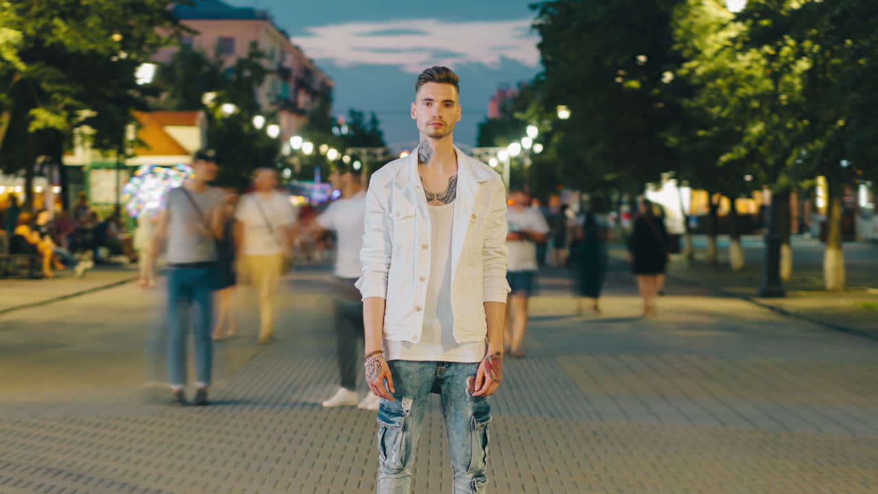 Man in a White Jacket at Night on a City Street