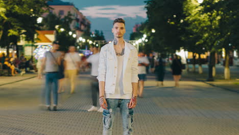 man in a white jacket at night on a city street