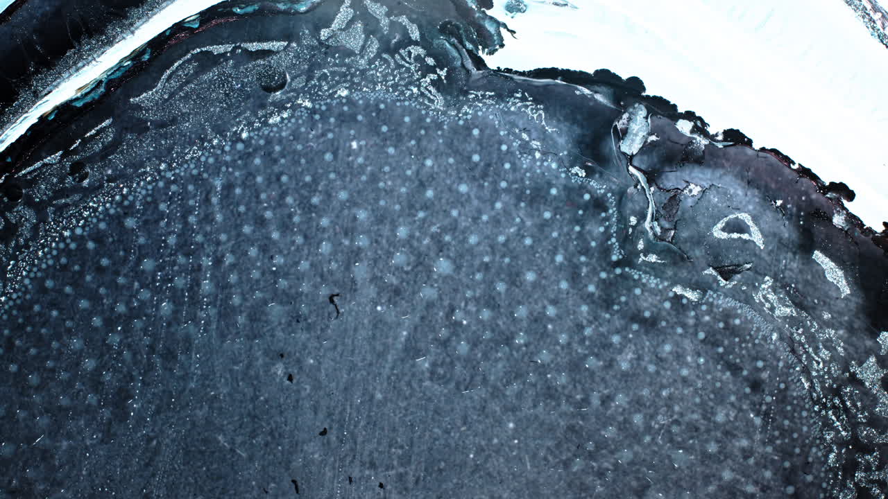 Macro view of dark liquids intermingling, mysterious and artistic vibe