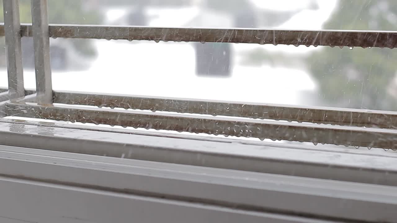 Rainy weather through window drops nearby