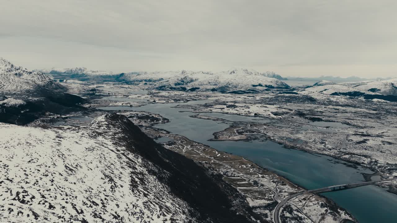Stunning Winter Landscape Of Lofoten Islands With Road Bridge Spanning The Fjord In Norway. - aerial shot
