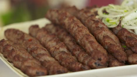 dinner table served with lula kebabs and fresh vegetables