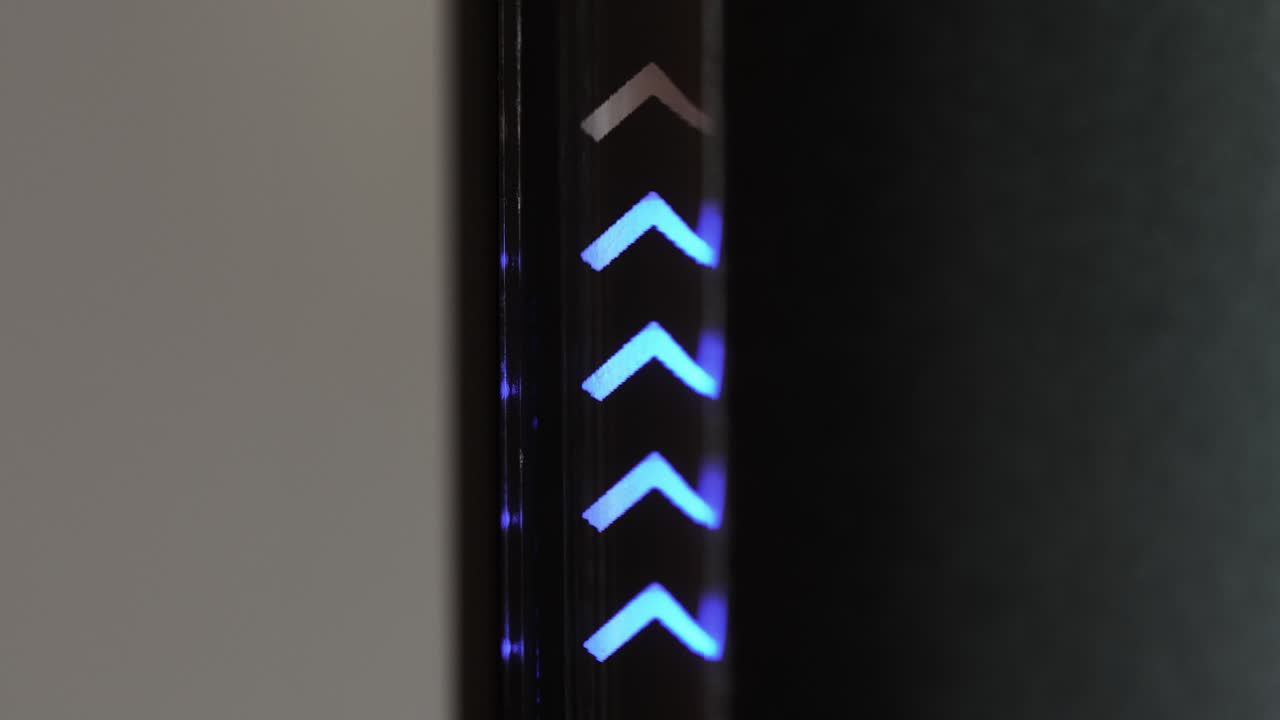 Close-up shot of a modern electronic device with blue LED lights dynamically charging up in a loopable motion