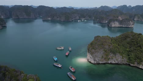 drone shot of boats docked at private beach in cat ba and halong bay in northern vietnam