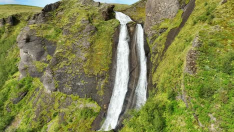 Tall-Double-Waterfall-in-Iceland-during-the-Summer-w-Lush-Green-Landscape-SLOMO