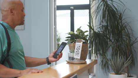 scanning qr code with smartphone, man checking in at prosthetic lab reception