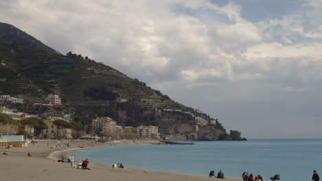 relaxing maiori coastline beach with tourists and beachgoers, italy