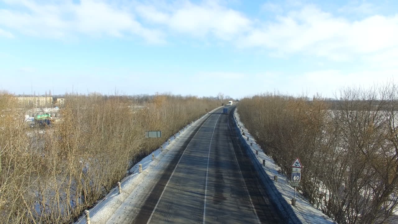 Asphalt road in snowy winter. Winter road with snow forests around