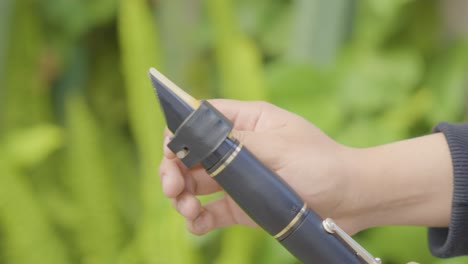 Close-Up-of-a-Clarinet-Being-Fine-Tuned-with-Follow-Focus-Panning-Shot