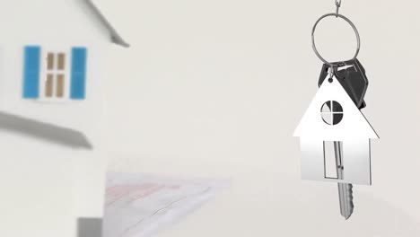 Animation-of-keys-and-house-model-over-white-background