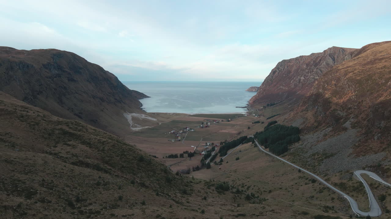 Drone flying into a small town in a valley looking into the horzion