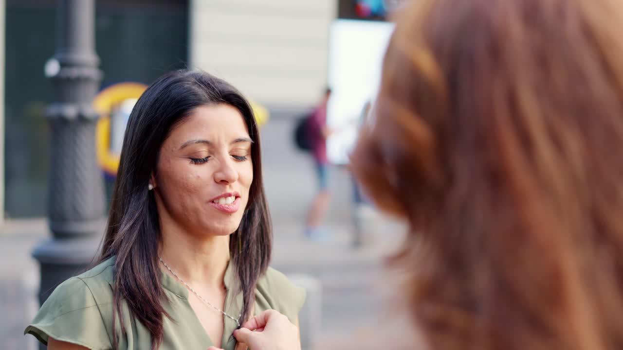 Two Women Engage in an Expressive Outdoor Conversation