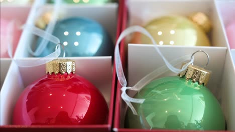 Close-up-view-of-colorful-Christmas-tree-balls-arranged-in-a-box