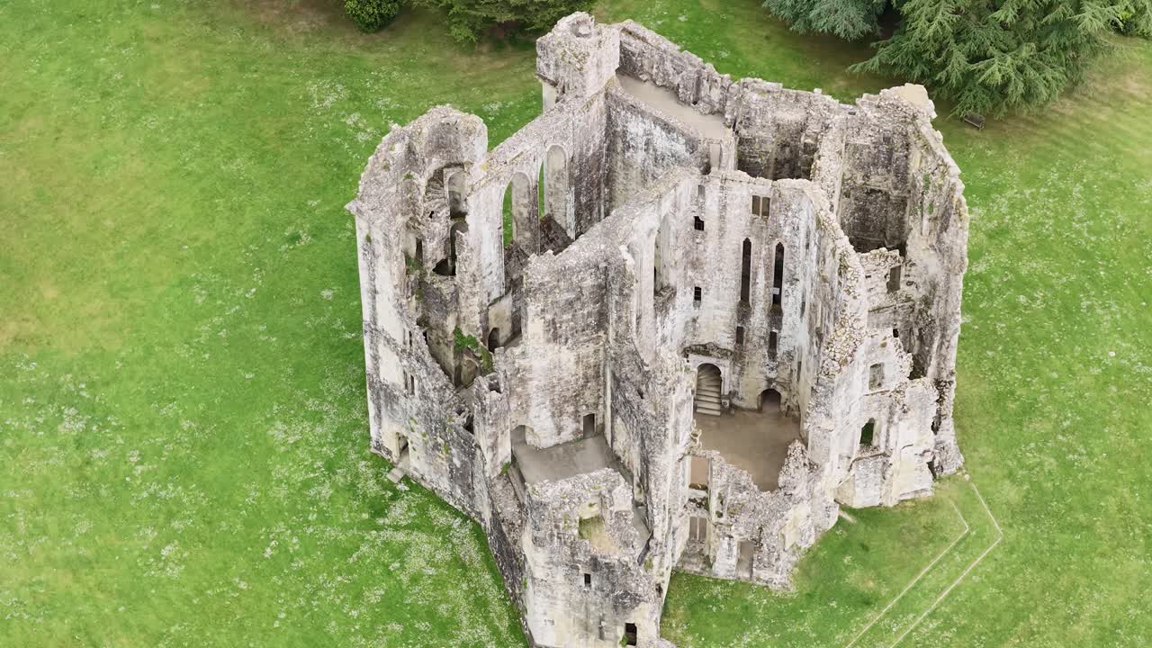 High-angle aerial view of interior of ancient Wardour Castle, medieval ruin surrounded by tranquility of English countryside