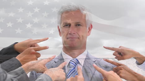 animation of flag of usa over fingers pointing at caucasian businessman