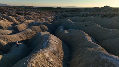 tourist walking on uneven terrain in desert