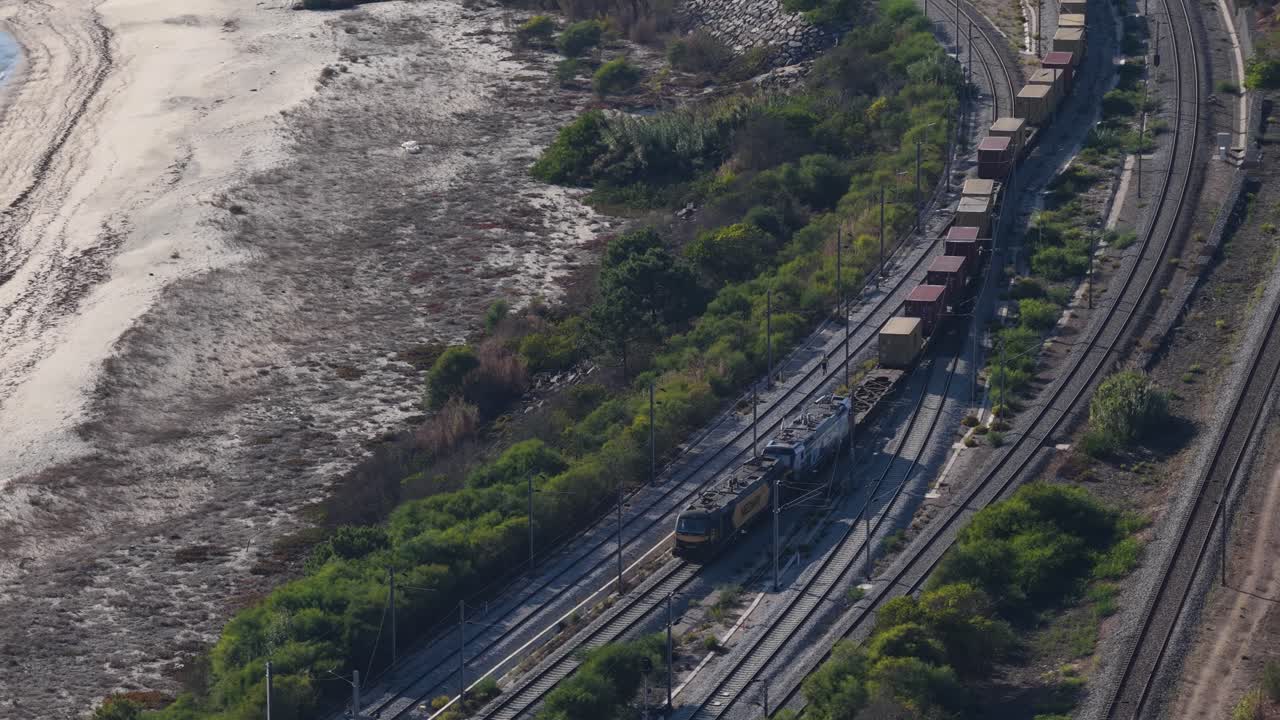 Train with shipping containers on the coast