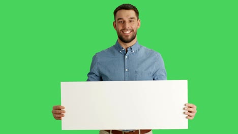 medium shot of a smiling stylish man holding poster/placard. shot on a green screen.