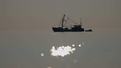fishing boat at sunrise/sunset
