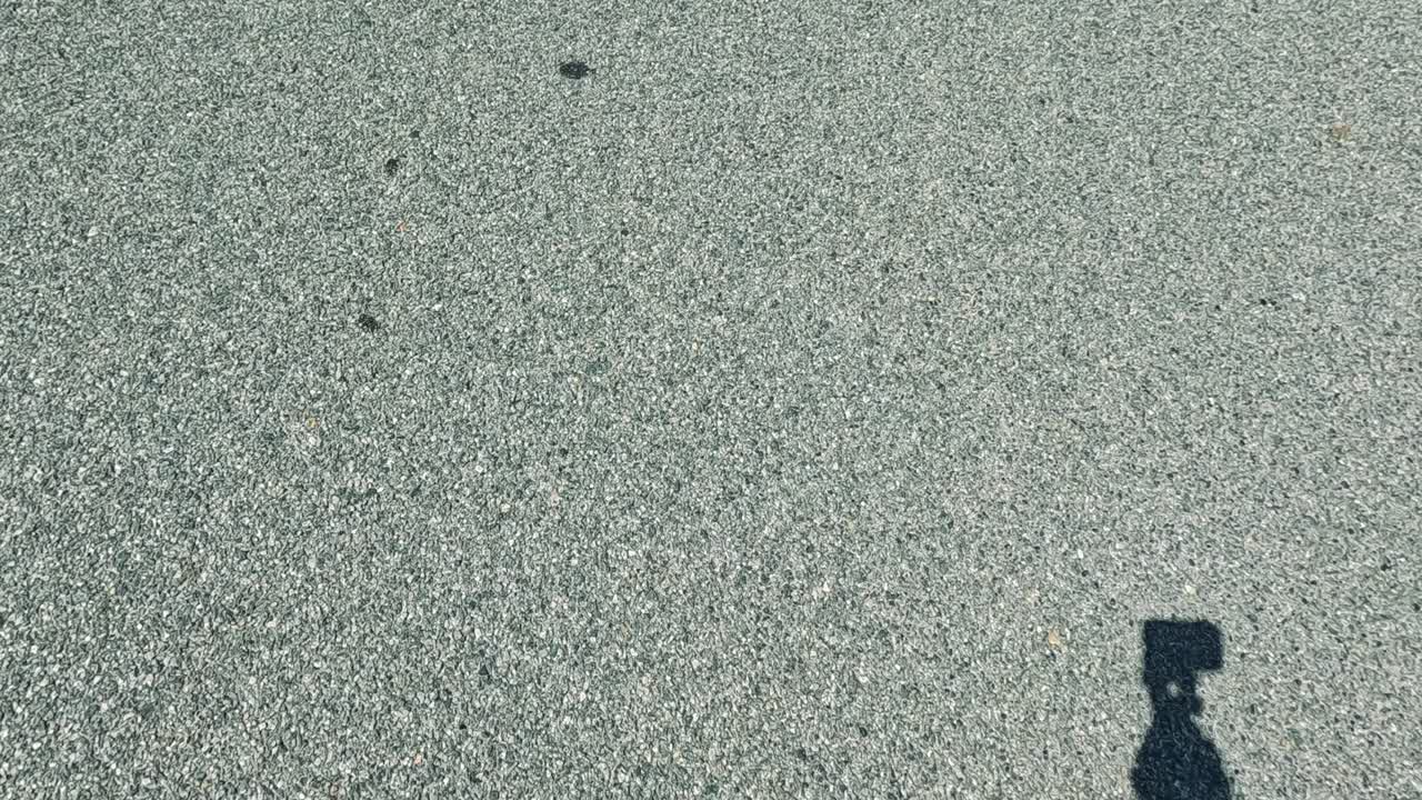 Shadows and feet on a sunny street