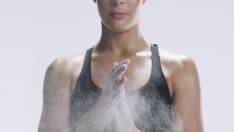 woman preparing for weightlifting with chalk