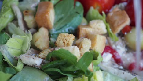 close-up of a caesar salad with croutons, tomatoes, lettuce, and dressing