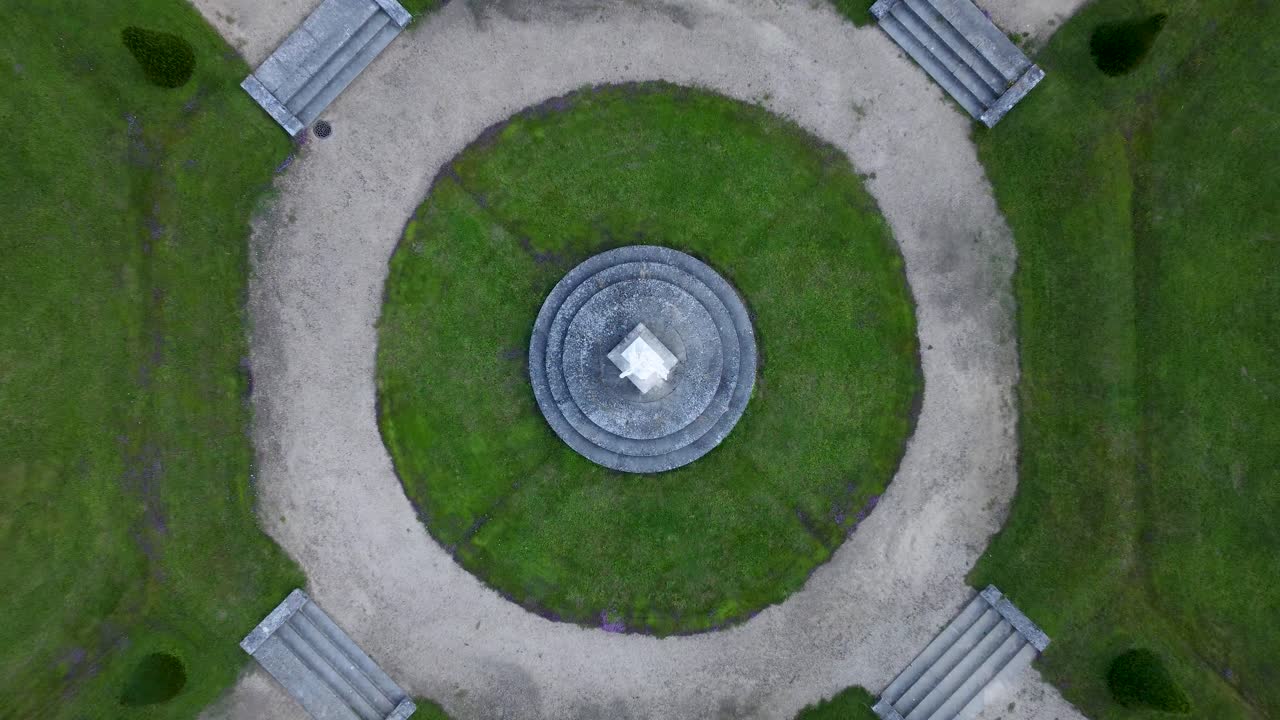 Zenital view of a garden statue, paths around