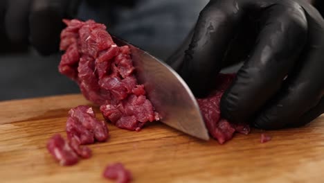 chef cutting raw beef