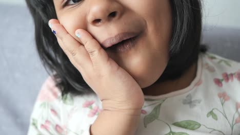 adorable little girl with hand on cheek