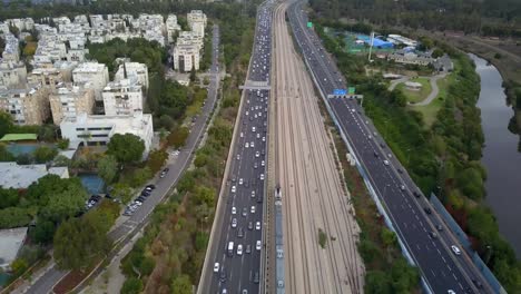 aerial footage over train, railway and highway with traffic