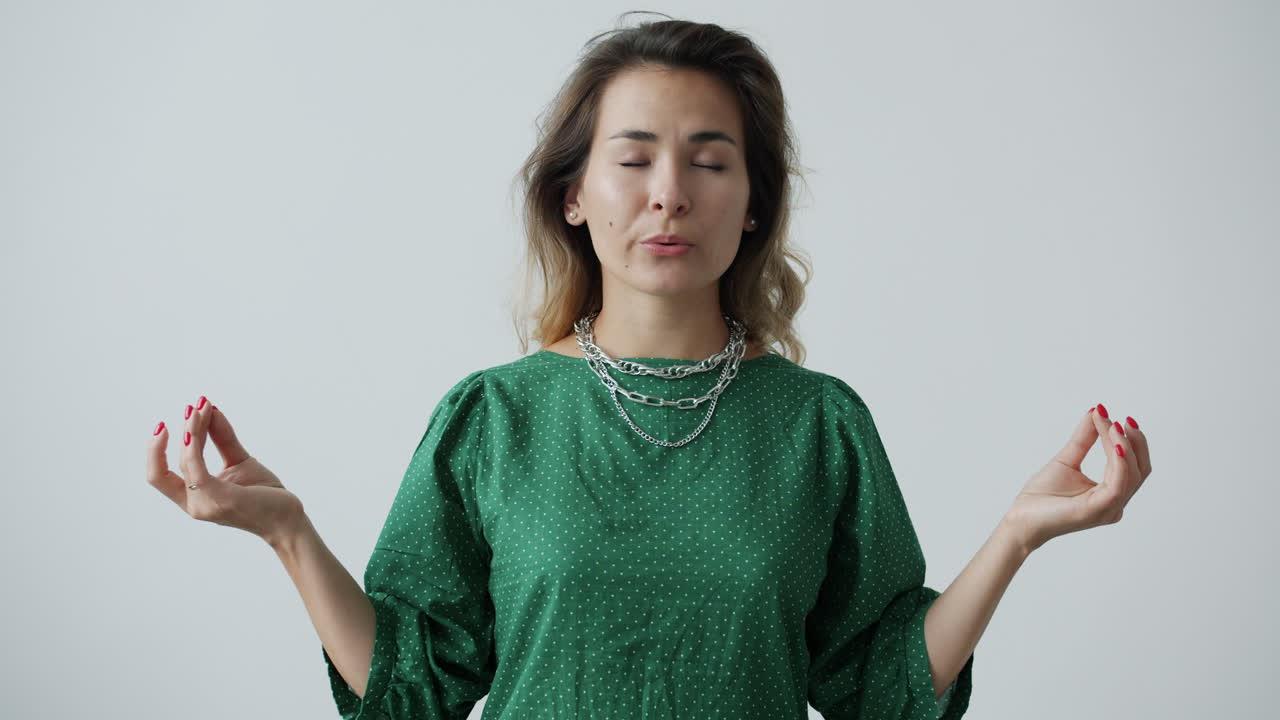 Woman Meditating in a Green Dress