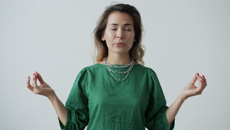 Woman Meditating in a Green Dress